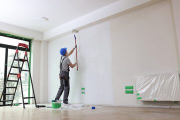 Decorator painting a ceiling