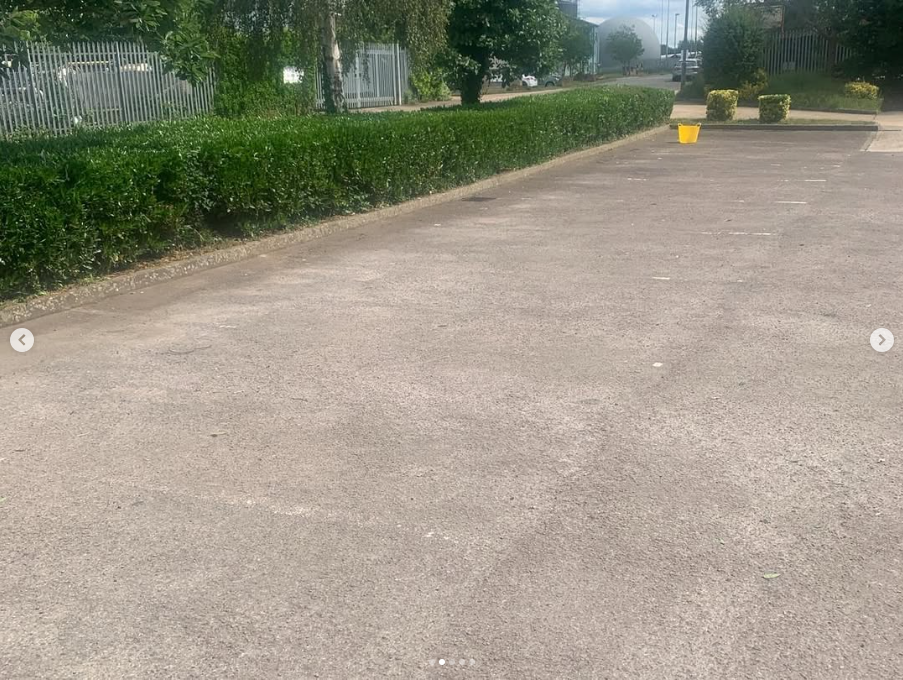 Carparking with trimmed hedge as boundary