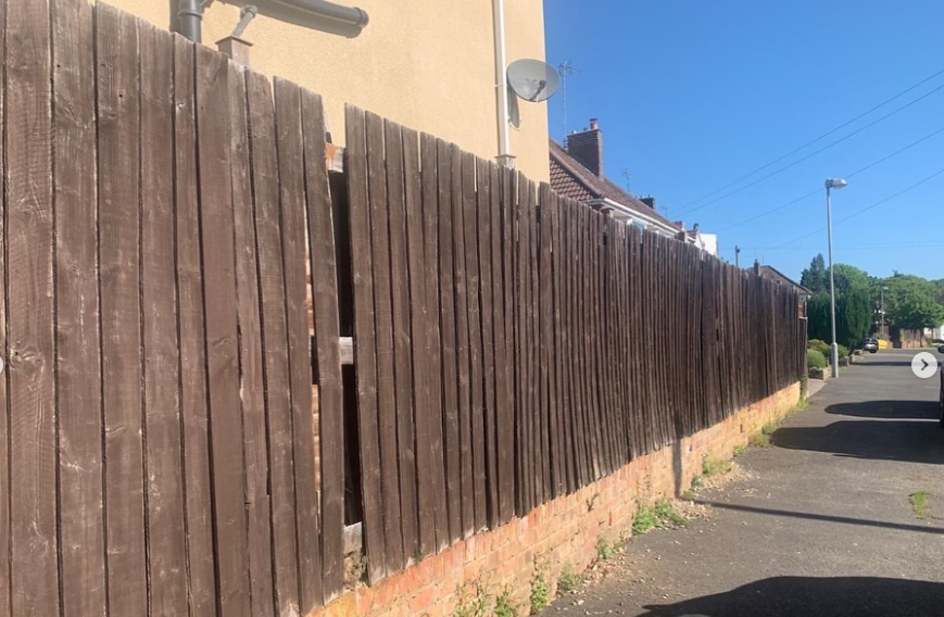 Screenshot 2025-07-12 170850 a wooden fence with a hole in the wall